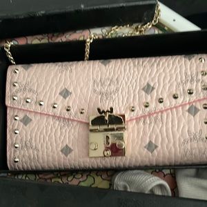 Pink MCM bag .. Grey lettering Comes with box and bag to put pocketbook in